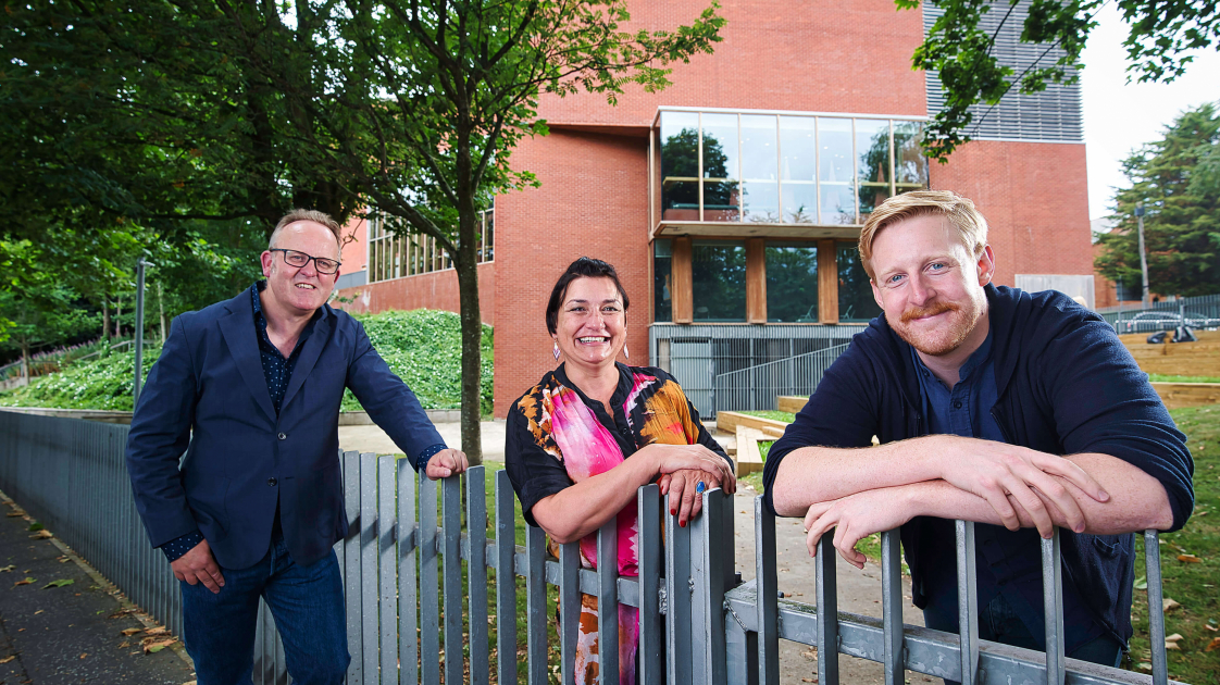 Jimmy Fay, Emma Jordan and Michael Patrick standing around the fence outside the Lyric Theatre