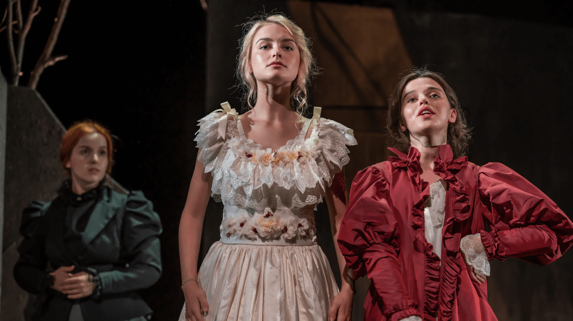 A still from the Lyric Drama Studio's production of Dracula, featuring three female actors on stage.