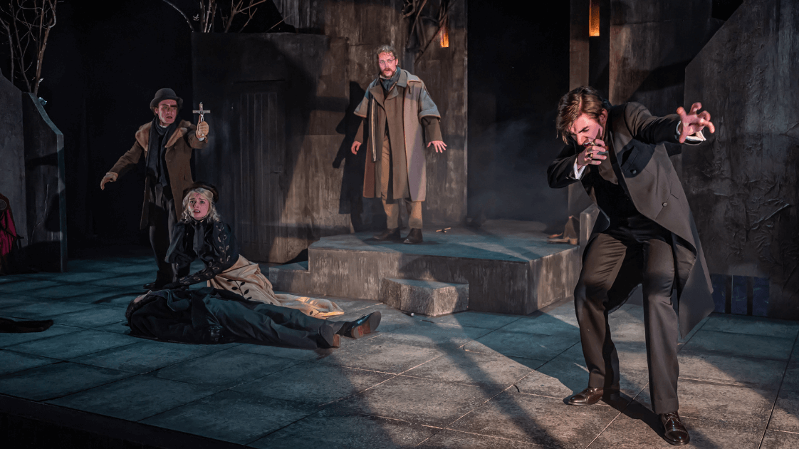 A still from the Lyric Drama Studio's production of Dracula, featuring five actors on stage.
