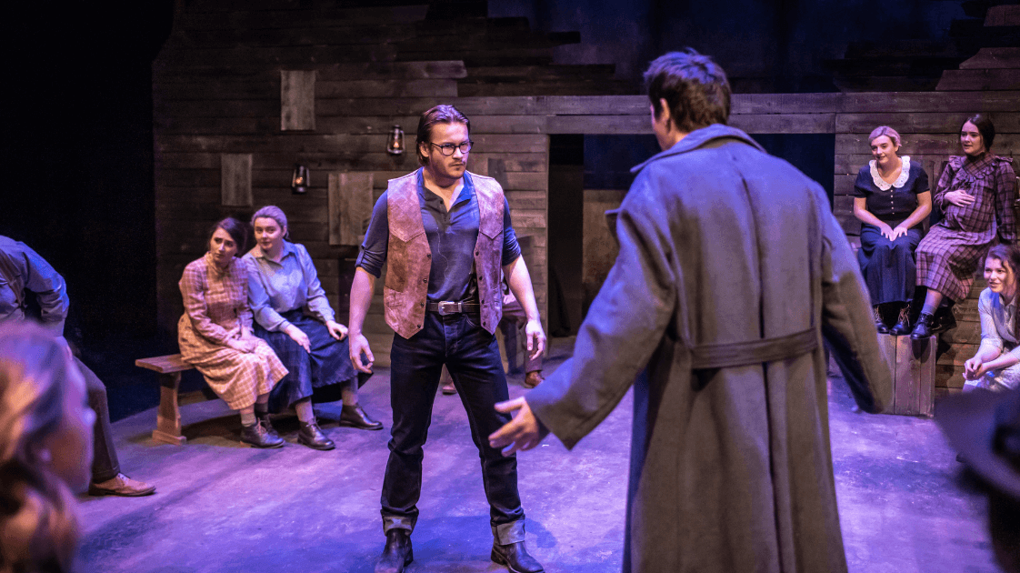A still from the Lyric Drama Studio's production of Dracula, featuring a group of actors on stage.