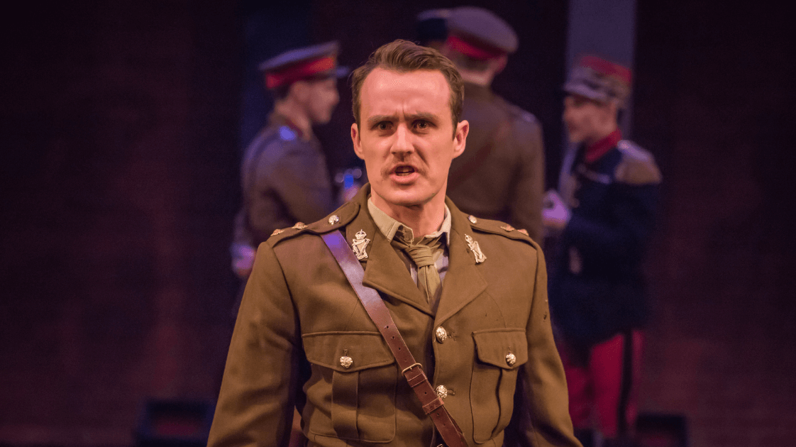 A still from the Lyric Drama Studio's production of Dracula, featuring an actor on stage wearing a soldier's costume.