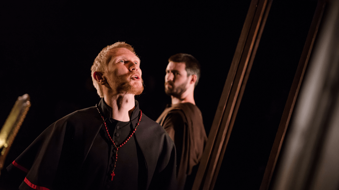 A still from the Lyric Drama Studio's production of Dracula, featuring two male actors on stage.