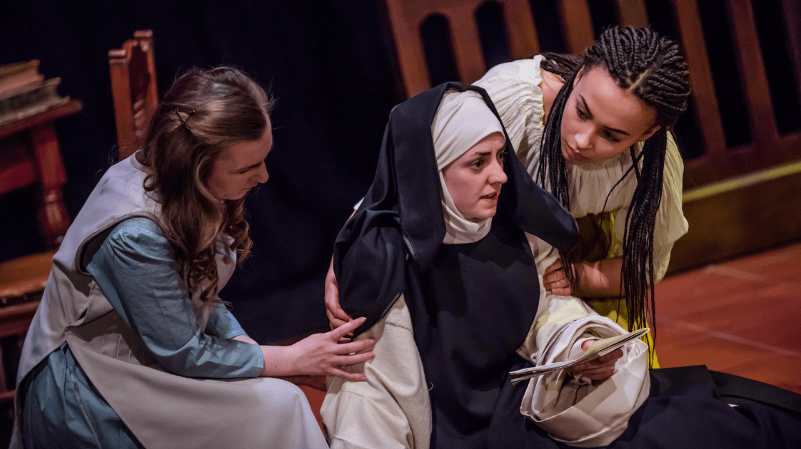 A still from the Lyric Drama Studio's production of Dracula, featuring three actors on stage.