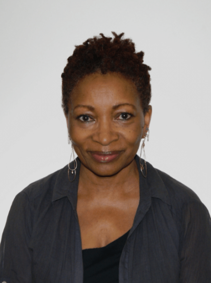 Bonnie Greer wearing a black top and grey shirt on a white background