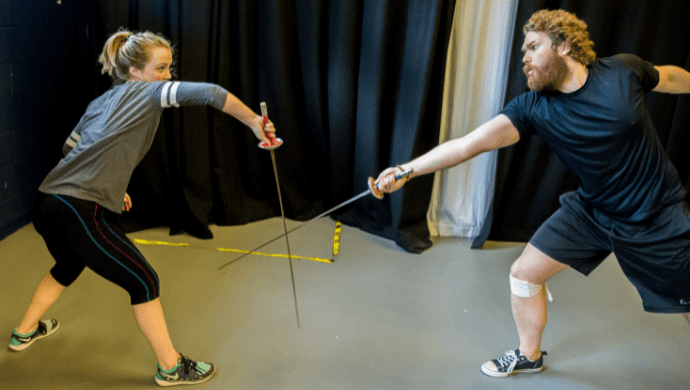 Two people fencing.