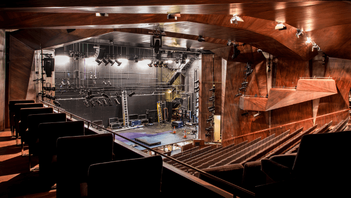 The empty Main Stage of the Lyric with house lights up.