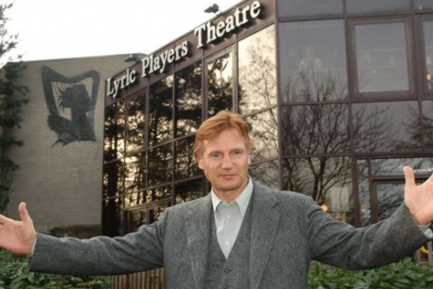 Actor Liam Neeson stands outside the old Lyric Theatre building.